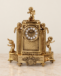 Mantel clock with three cherubs and patterned panels