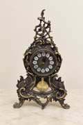 Louis XV-style mantel clock with visible pendulum