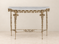 Ornate Console Table with Twin Mask Detail — ivory wall and cream marble setting.